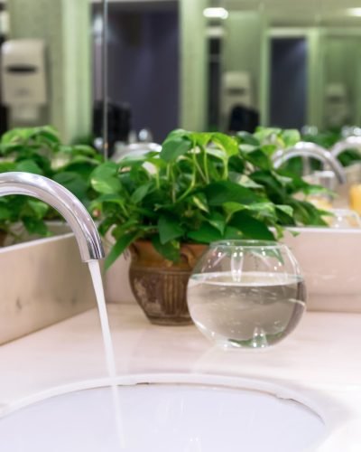 Chrome faucet with washbasin in modern bathroom