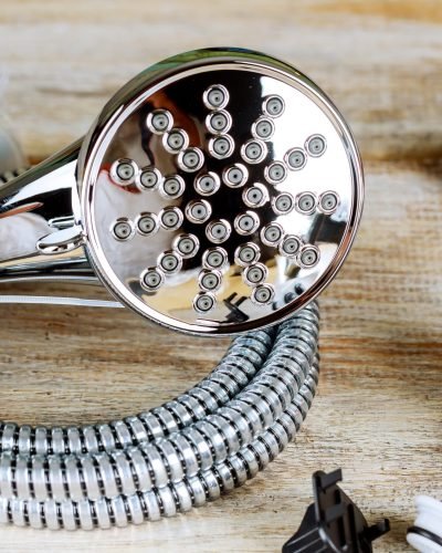 Pipe wrench copper plumbing fixtures rolled up construction drawings.