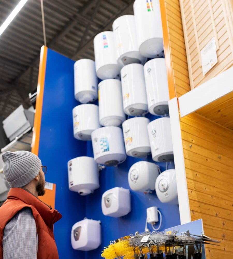 the buyer chooses a boiler for his house in a hardware store.
